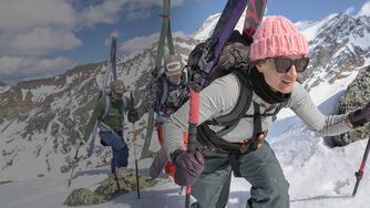 Backcountry skiers hiking to the top of a mountain.