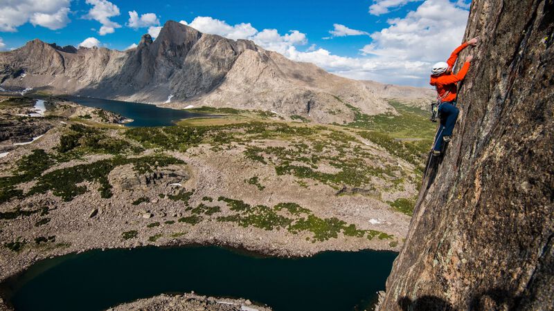 A climber reaches for the next hold.